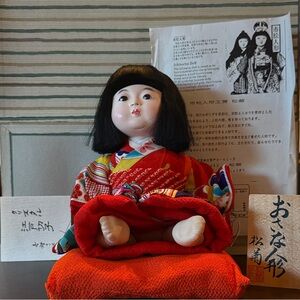 Elegant Japanese Doll with Vibrant Red Kimono